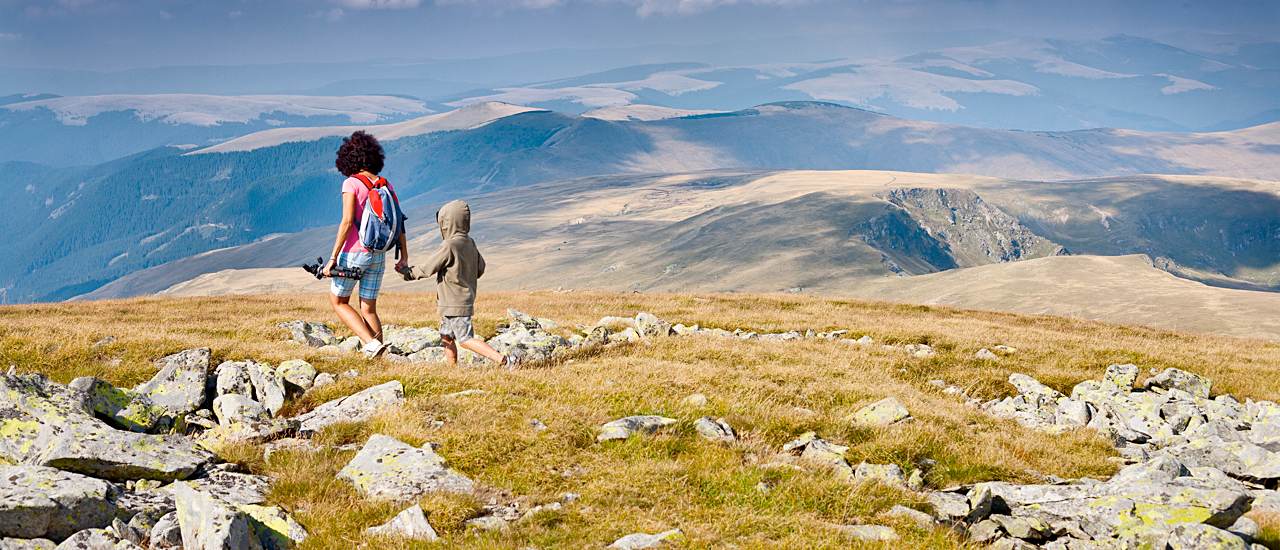 Mother and son walking in the mountains