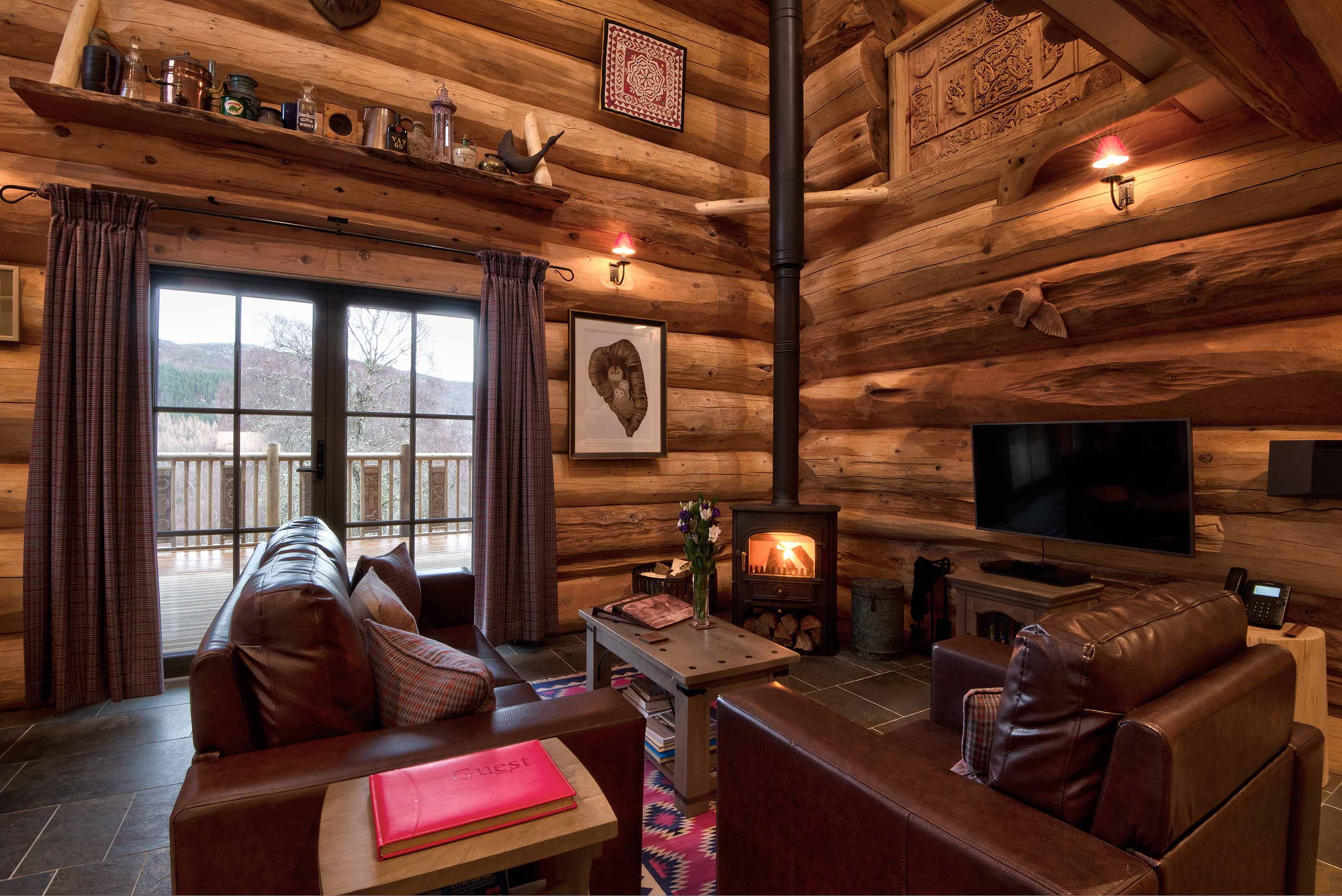 Log cabin interior in winter with log fire