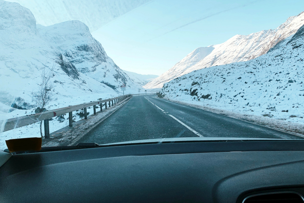 View through car windscreen of snowy landscape