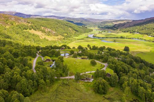 Aerial view of luxury turf roof log cabins near Beauly, Inverness-shire