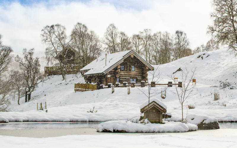 Snow covered log cabins at Eagle Brae