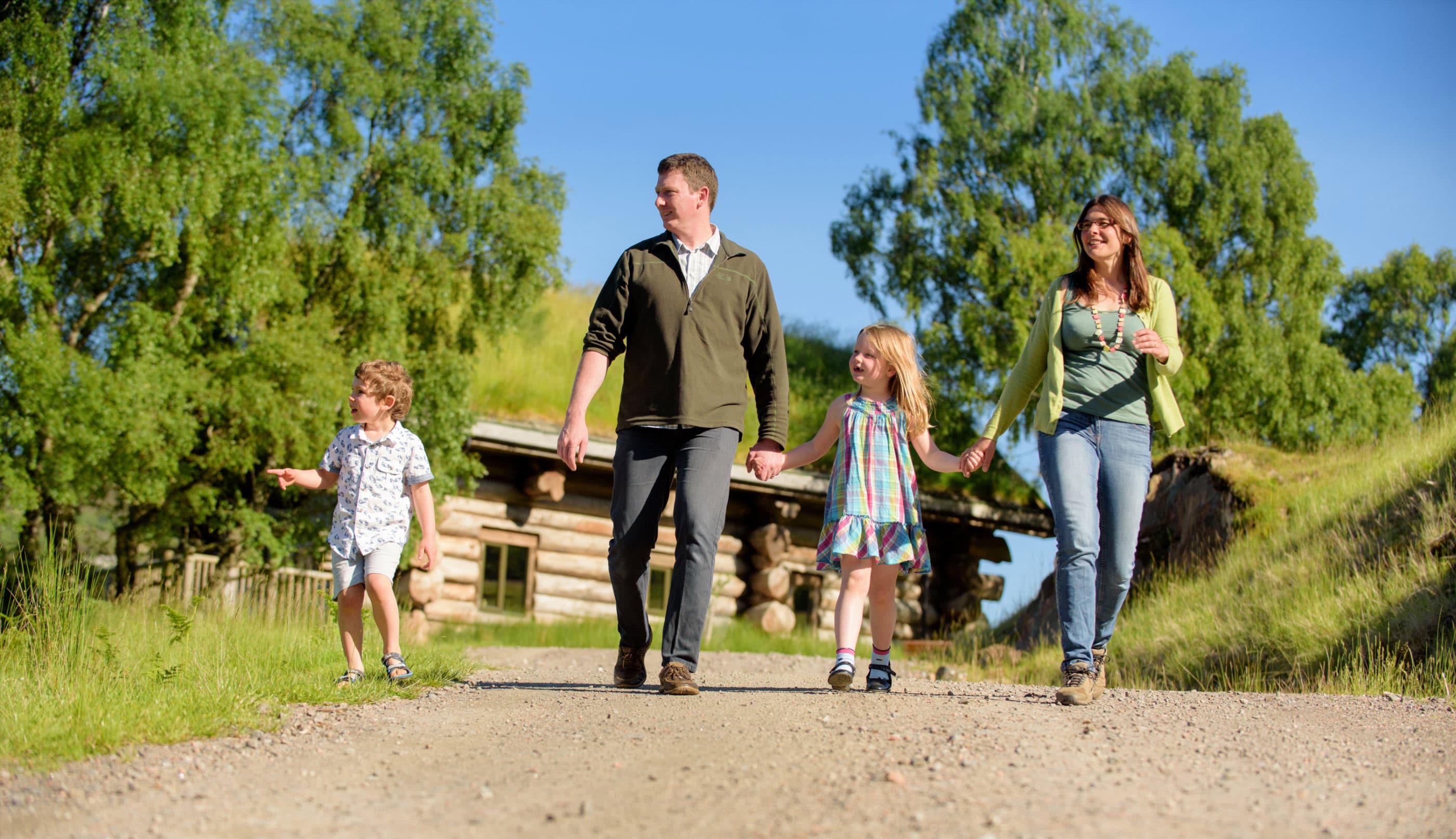 Family walks through Eagle Brae's grounds on a nice day