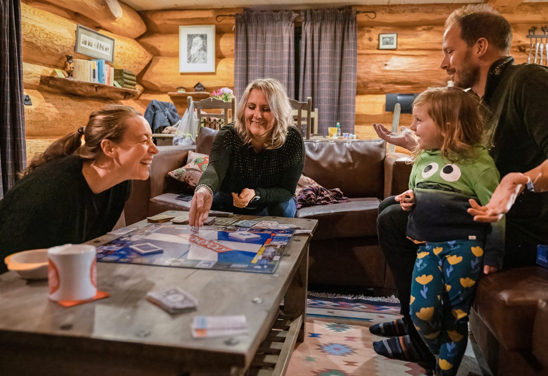Family using the games in Eagle Brae cabin