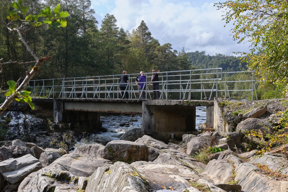 Walkers on bridge over River Affric at Dog Falls