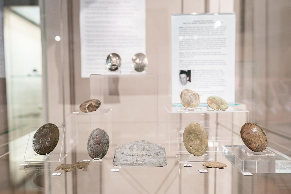 Historical Artifacts, old money in a glass cabinet in inverness museum and art gallery.