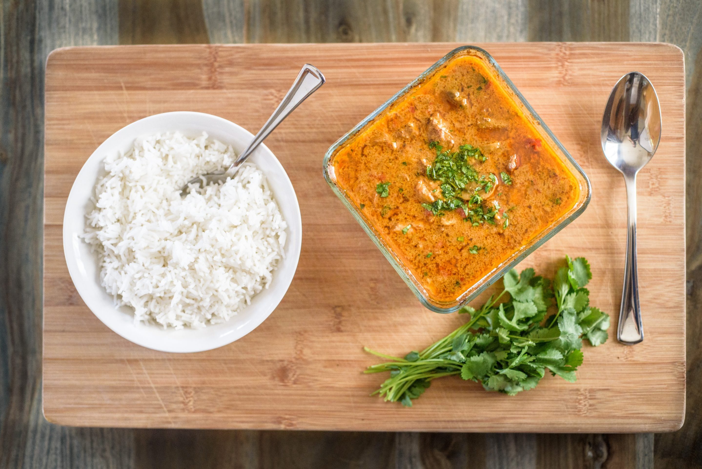 Homecooked Eagle Brae Pondicherry pork curry served on a board with rice and green vegatables