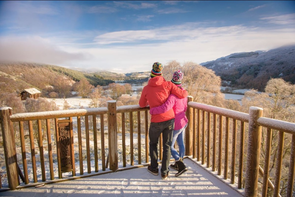 Couple stood on decking looking out over Eagle Brae