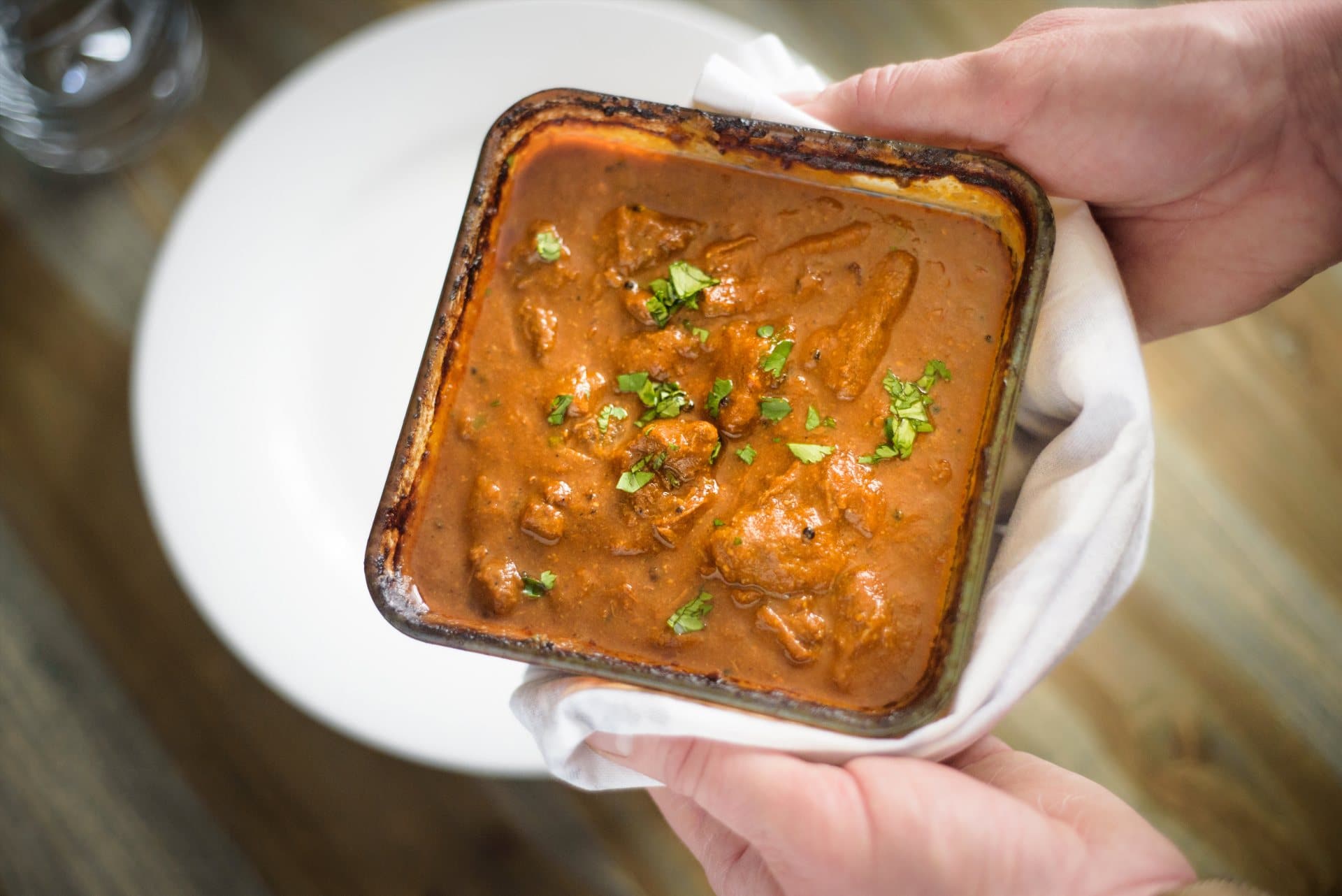 Eagle Brae's Venison Curry being carried from the oven to the plate