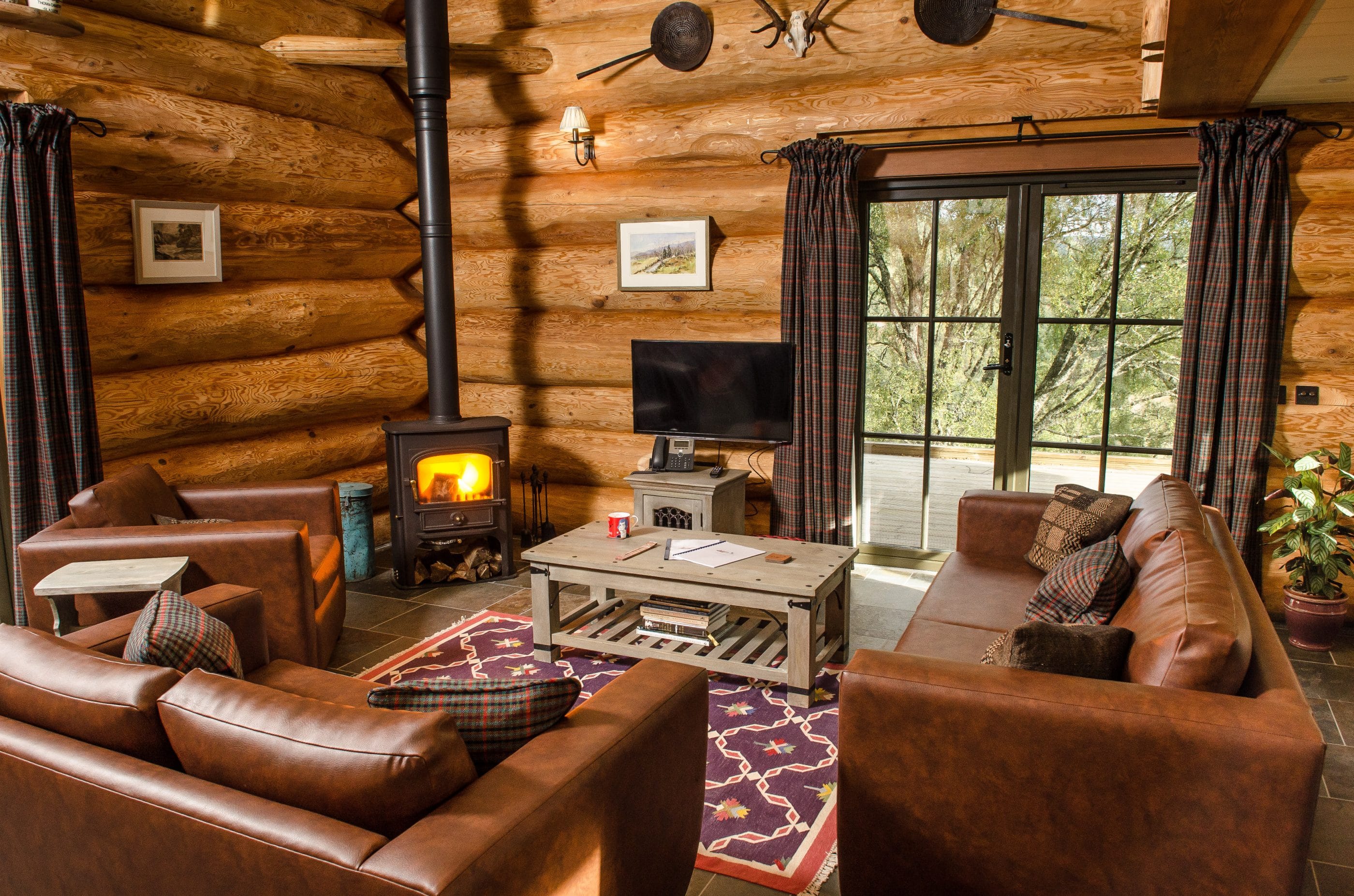 Log cabin living room with log burner