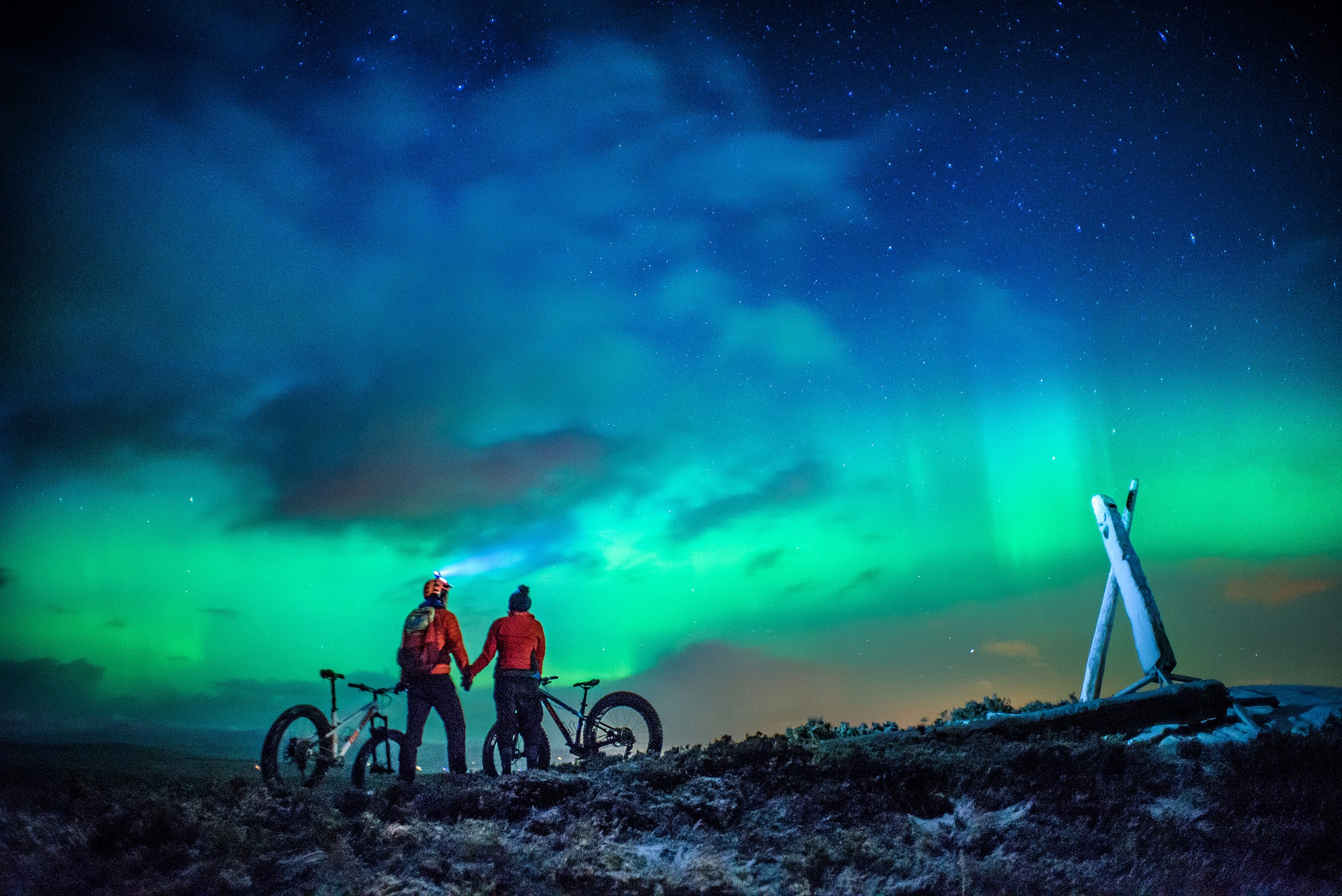 Cyclists enjoying the Northern Lights