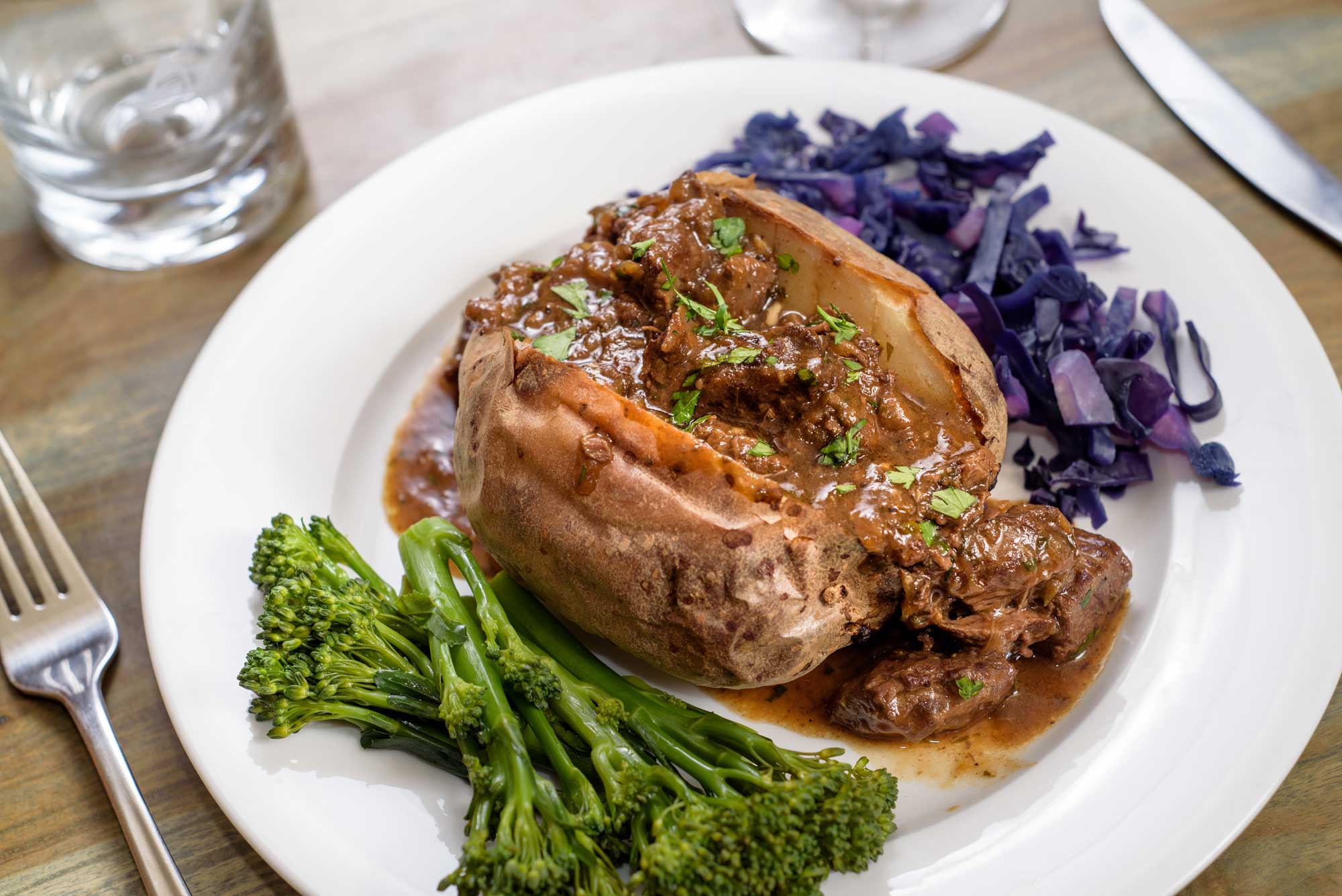 Venison carbonnade with vegetables served on a white plate